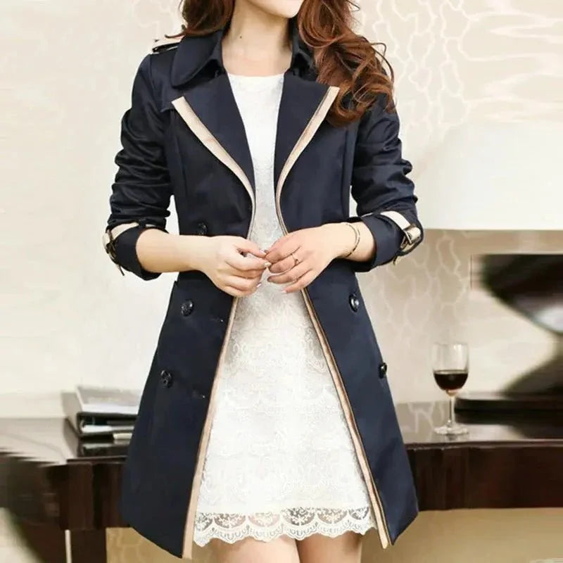 Women's double-breasted long trench coat by TrendLux Wear, shown in a classic beige outerwear style with collar and belt details.