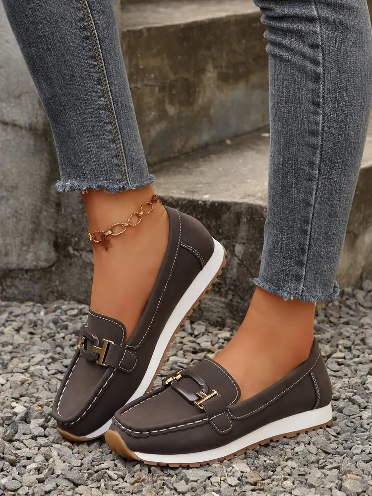 Women's slip-on flat shoes with buckle detail by TrendLux Wear, featuring a sleek design and comfortable fit.
