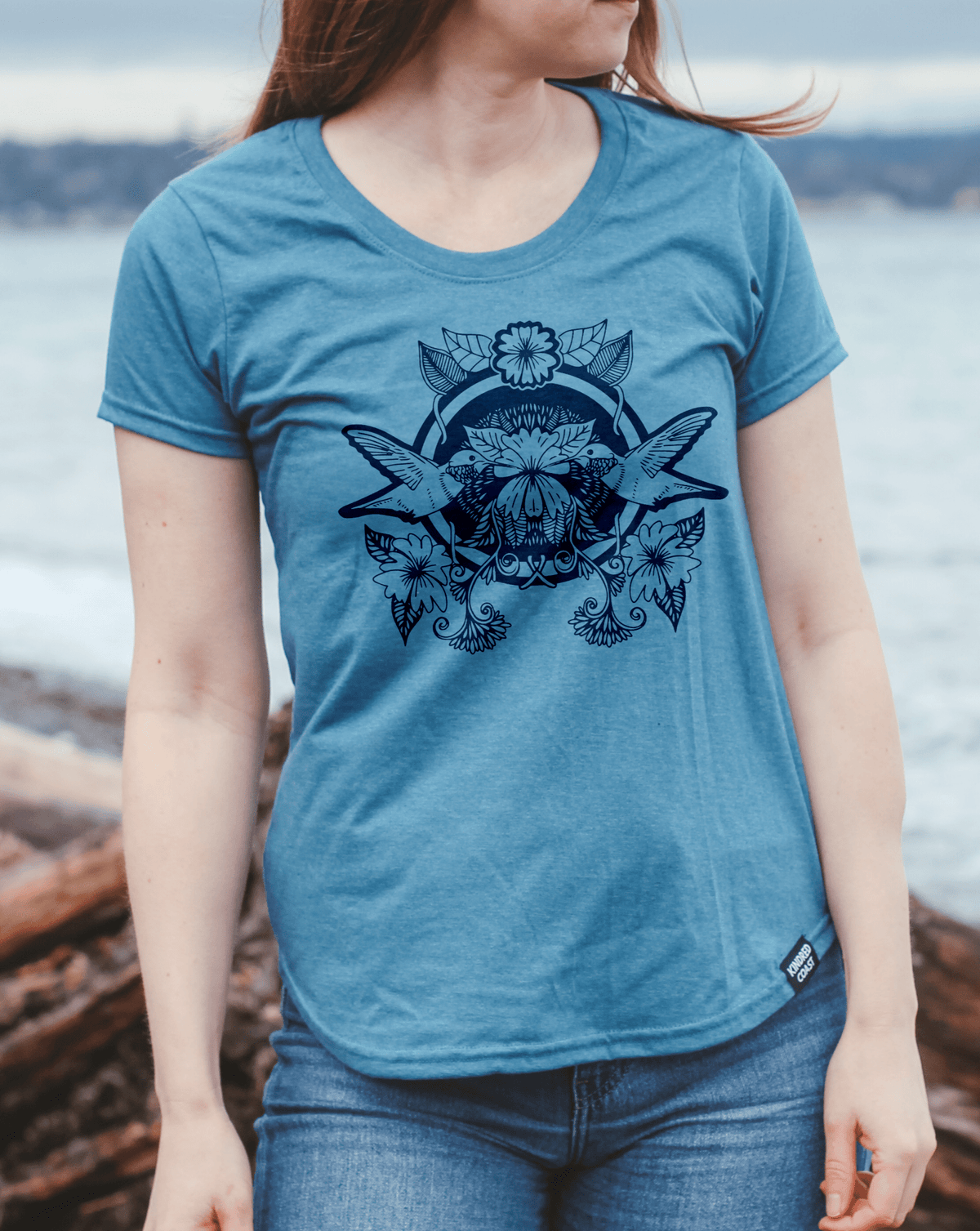 Women's eco-friendly teal T-shirt with hummingbird graphic by KINDRED COAST, casual fit and soft fabric.